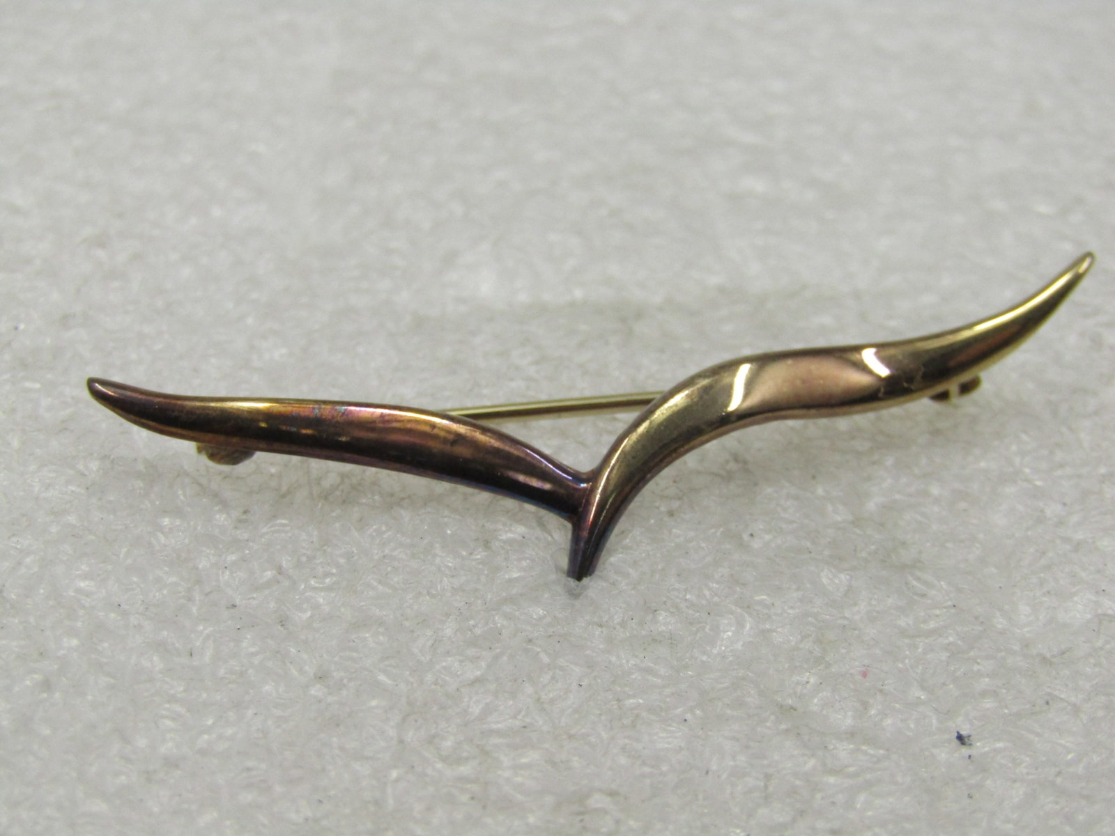 Vintage Sterling Vermeil V Brooch, 1960's-1980's: Vintage Sterling Vermeil V Brooch, 1960's-1980's. It is signed with a star pictograph and under that vermeil. It tests as stering at appx. 2.15 grams. It has the look of a seagull but it is an