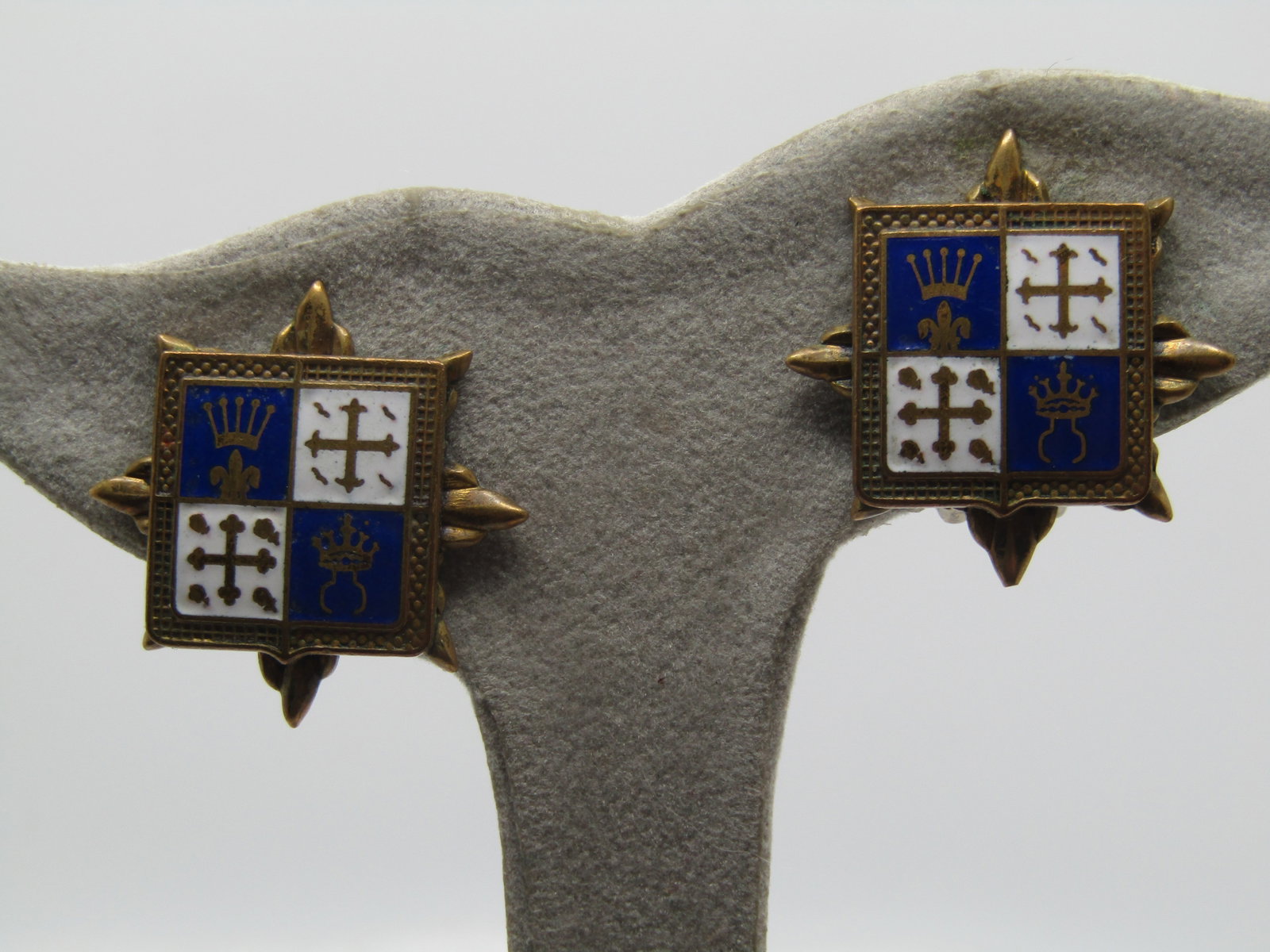 Vintage Enameled Coat-of-Arms Earrings, Clip, 1940's-1950's: Vintage Enameled Coat-of-Arms Earrings, Clip, 1940's-1950's. Enameled in white and blue with crowns and crosses and a fleur-de-lis. Medeval themed. There are pointed accents that come out from under