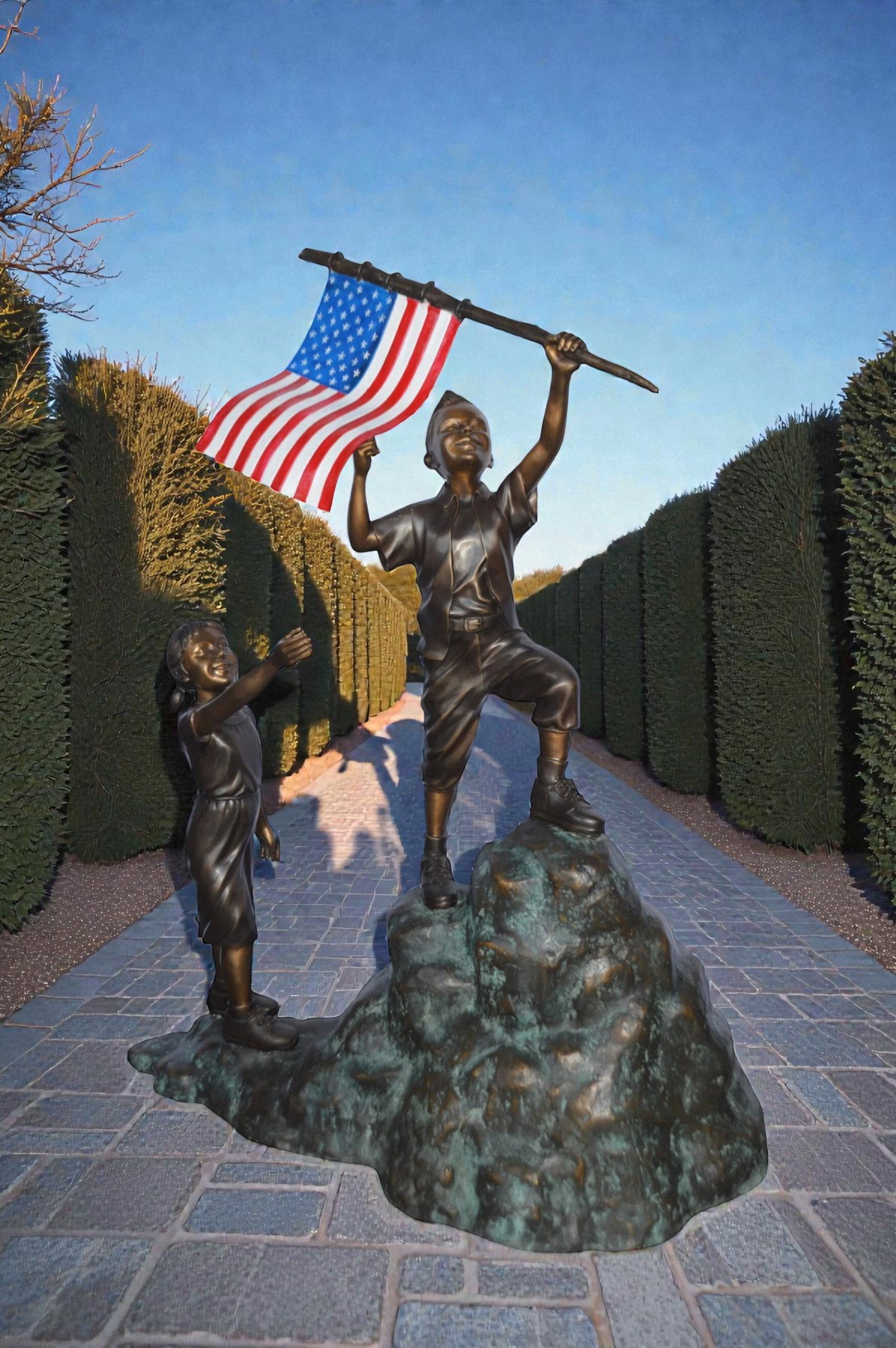 Two Kids on Rock W the American Flag Bronze Statue - Size: 50"L x 22"W x 58"H. - 2