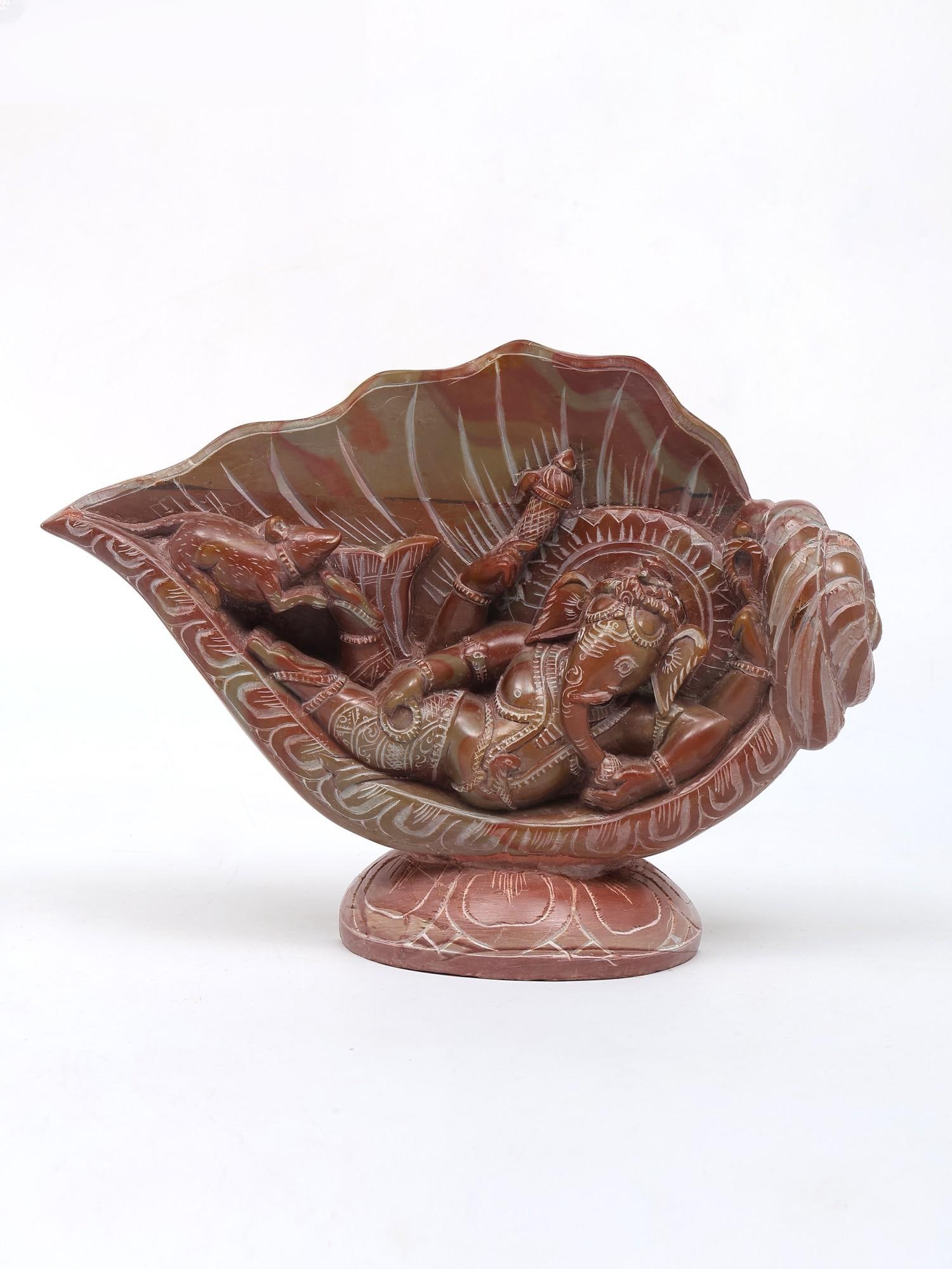 8" Relaxing Lord Ganesha Under The Conch / Relief Sculpture from Orissa: Title: 8" Relaxing Lord Ganesha Under The Conch / Relief Sculpture from Orissa Description: Additional Information: itemcode: DDO994 Reserve: $202.00 Shipping: Domestic: Shipping rates are determined