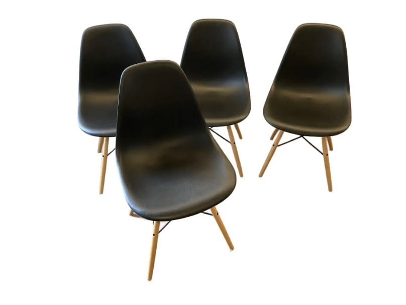 Set of Four Eames Molded Plastic Side Chairs with Wood Dowel Bases: A set of four iconic Eames molded plastic side chairs, designed by Charles and Ray Eames. The chairs have been used. One of the dowel legs is cracked and the glide was lost. The glide could be