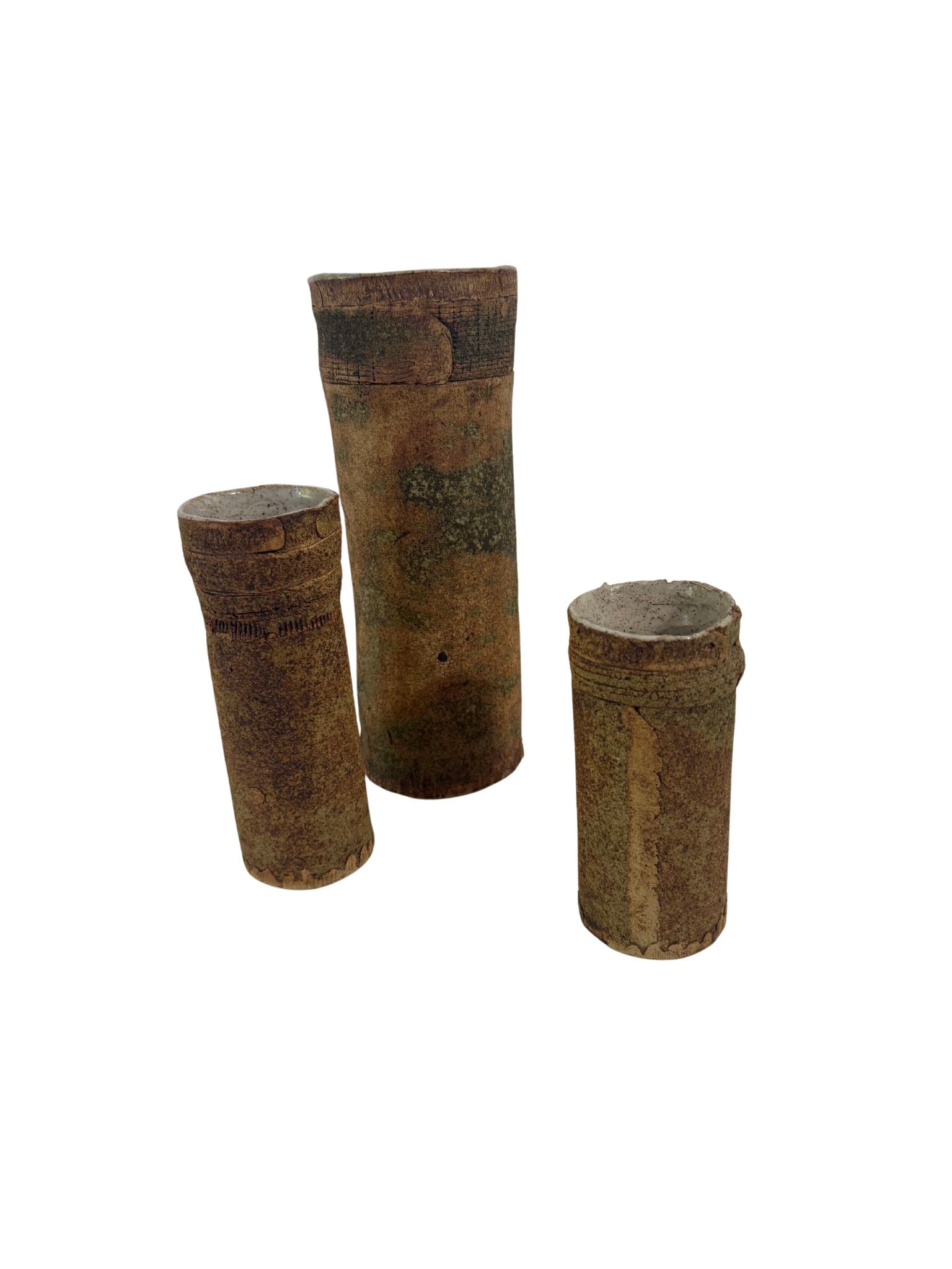 Trio of Brutalist Coral-Sand Cylindrical Vases, signed and dated, Donald Schnell: Three cylindrical hand-thrown vessels in various heights. Features a textured exterior of local clay and crushed coral sand with incised primitive markings and a glazed interior. The two larger