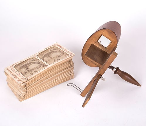 Antique French stereoscopic viewer 19th. with 30 views: In n 1861 Oliver Wendell Holmes created and deliberately did not patent a handheld, streamlined, much more economical viewer than had been available before. The stereoscope, which dates from the