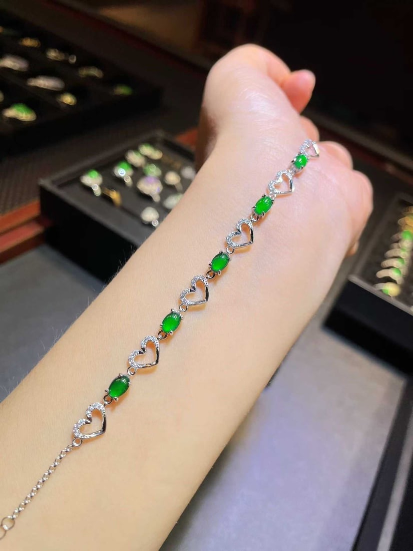 Silver Natural Jadeite Bracelet: Title: Silver Natural Jadeite Bracelet Description: This bracelet is crafted from selected natural jadeite, showcasing an enchanting green hue. Each jadeite piece is carefully chosen, with a stylish d