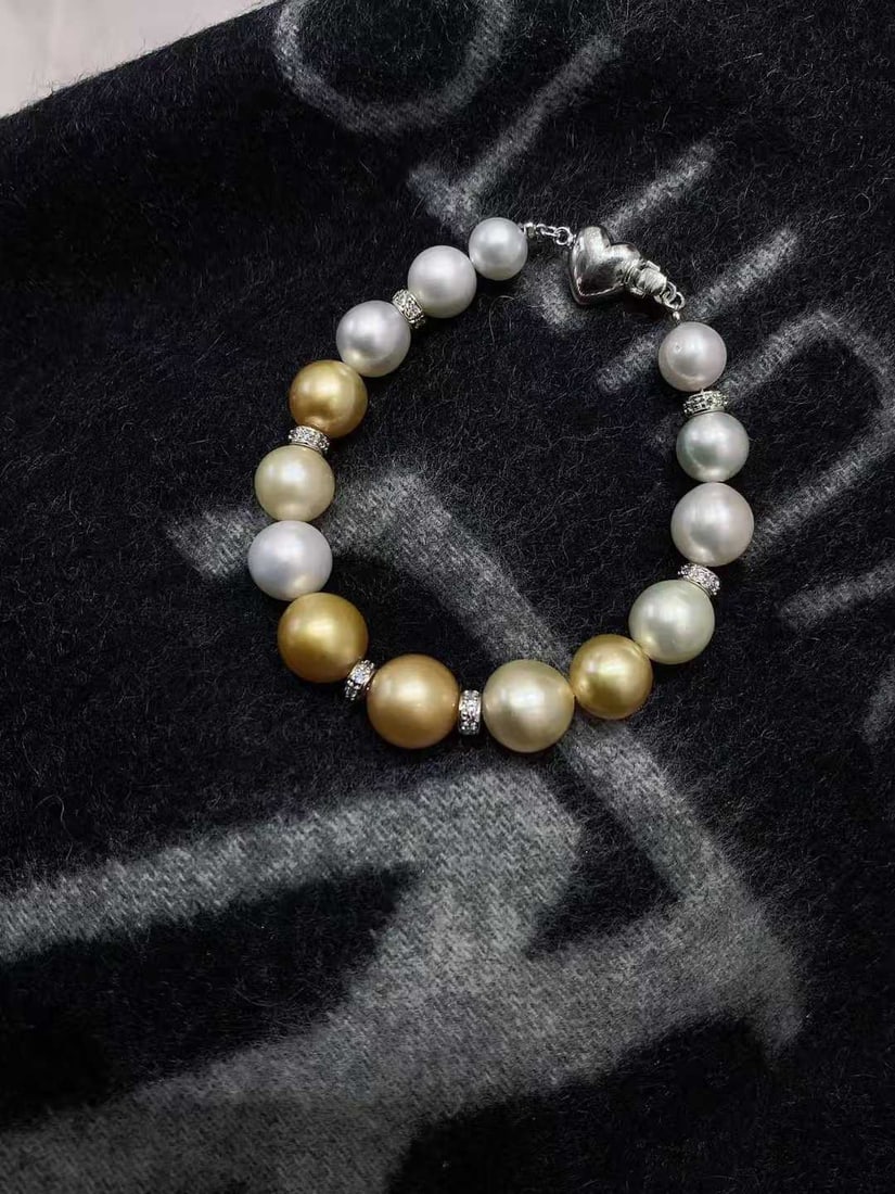 Natural White South Sea Pearl Bracelet: Title: Natural White South Sea Pearl Bracelet Description: This bracelet features natural white South Sea pearls, nearly round with slight blemishes, showcasing a gentle hue. Suitable for daily wear