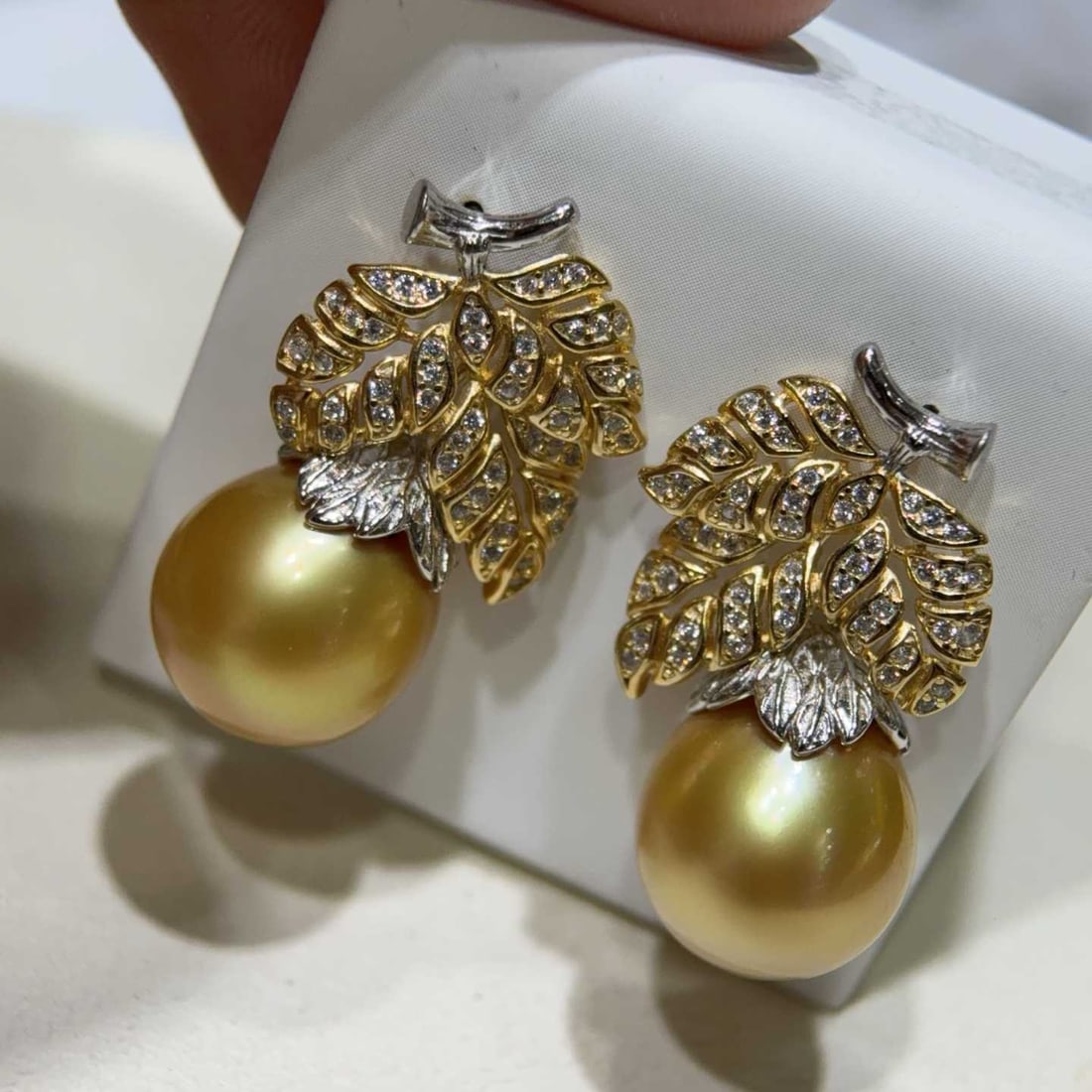 Natural Golden Pearl Earrings: Title: Natural Golden Pearl Earrings Description: These earrings showcase the exquisite luster of 12-13mm natural golden pearls, with a smooth and delicate surface that captivates at first sight. The