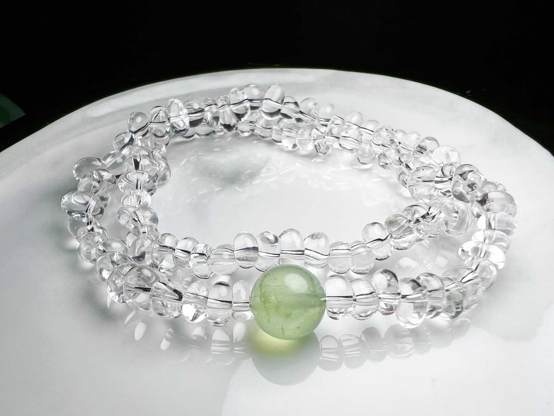 Natural White Crystal Prehnite Bracelet: Title: Natural White Crystal Prehnite Bracelet Description: This bracelet is meticulously crafted with natural white crystal and prehnite round beads, showcasing a harmonious beauty of nature. The