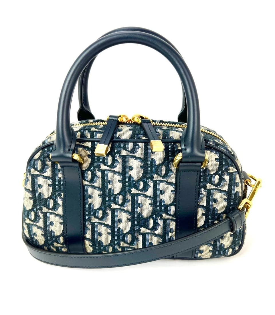 Christian Dior Oblique East West Nano D-Vibe Navy Bowling Bag: Title: Christian Dior Oblique East West Nano D-Vibe Navy Bowling Bag Description: Pre-Owned 100% Authentic Christian Dior Oblique East West Nano D-Vibe Navy Bowling Bag RATING: A...excellent, near