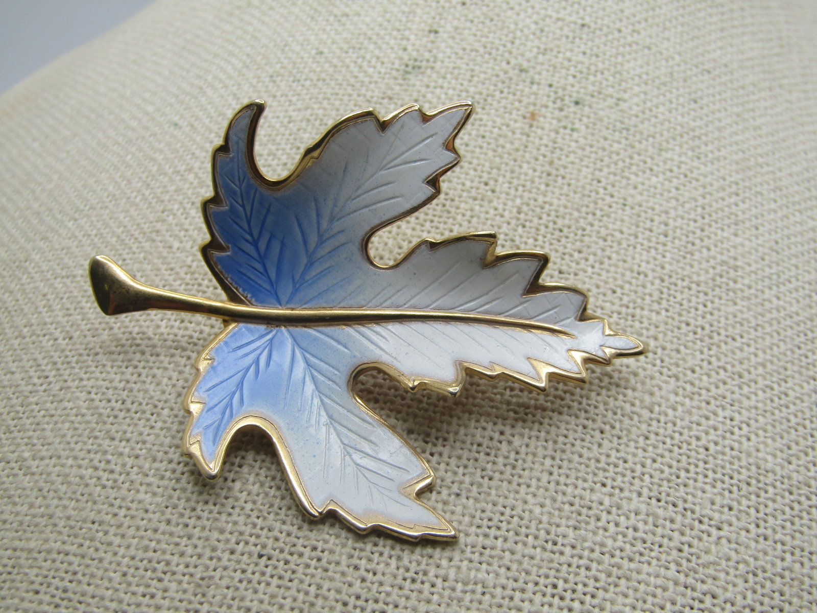 Vintage Blue & White Enameled Leaf Brooch, 1960's-1970's: Title: Vintage Blue & White Enameled Leaf Brooch, 1960's-1970's Description: Vintage Blue & White Enameled Leaf Brooch, 1960's-1970's. A maple leaf that is curved and gold tone with gold tone stem and