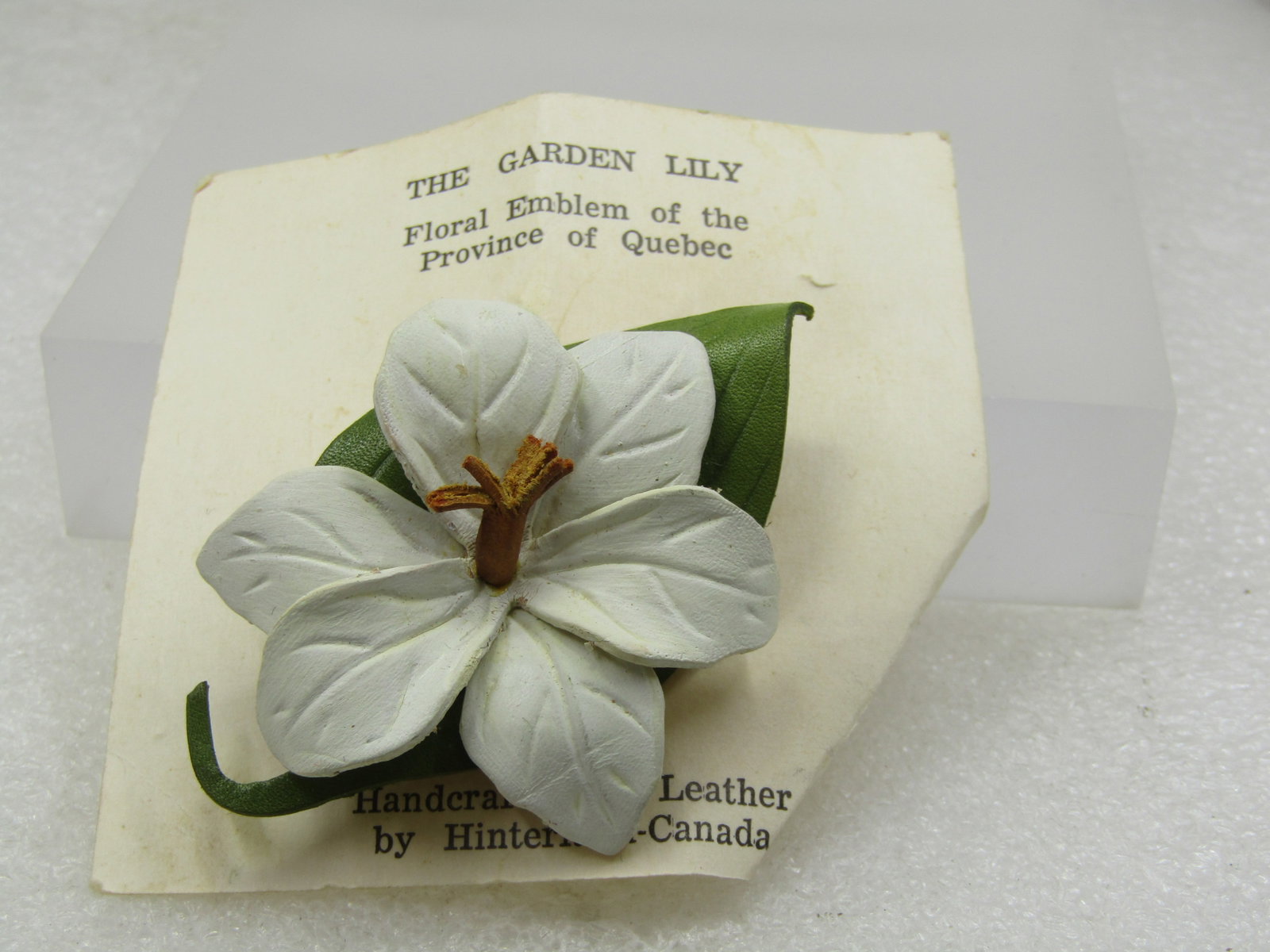 Vintage Leather Garden Lily Brooch, Hinterland-Canada, On Card: Title: Vintage Leather Garden Lily Brooch, Hinterland-Canada, On Card Description: Vintage Leather Garden Lily Brooch, Hinterland-Canada, On Card. The brooch is white and green leather with brown
