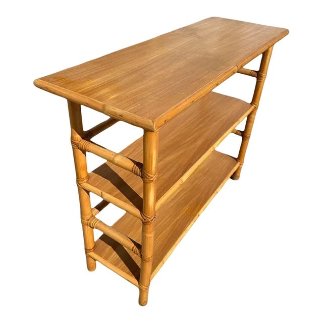 Restored Mid-Century Rattan and Mahogany Bookcase Console Table: Title: Restored Mid-Century Rattan and Mahogany Bookcase Console Table Description: Postwar three-tier console table Bookshelf with mahogany tops and a wrapped stick rattan frame. The table has mahoga