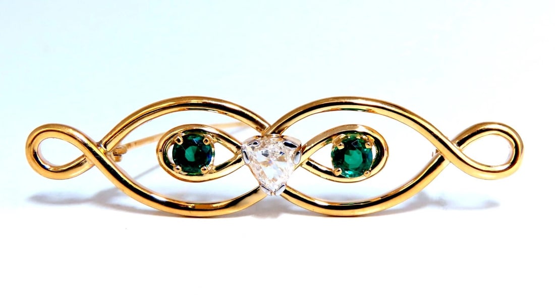 Natural Trilliant Diamond Emerald Infinity Pin 14kt**: Title: Natural Trilliant Diamond Emerald Infinity Pin 14kt** Description: Infinity Design Pin Very Well Made .70ct Natural Trilliant diamond. K-color Si-1 clarity .80ct natural Emeralds (2) Pin measur