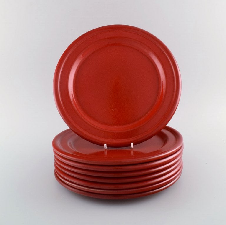 Emile Henry, France. Eight dinner plates in glazed stoneware. Beautiful glaze in shades of red. Mid - 2