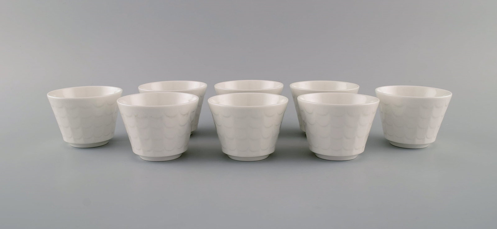 Wilhelm Kåge for Gustavsberg. Eight cups in white glazed porcelain. Swedish design, 1960s. (1 of 6)