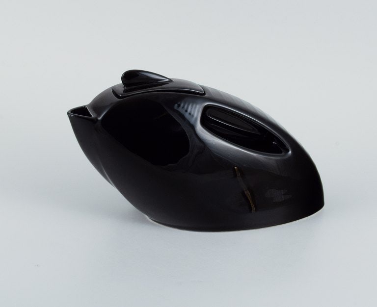 Black designer teapot in porcelain. Late 1900s.: Black designer teapot in porcelain. Late 1900s. In perfect condition. Marked. Measure: L 29 cm. x W 11 cm. x H 17 cm. Reserve: $252.00 Shipping: Domestic: Shipping rates are determined by destination