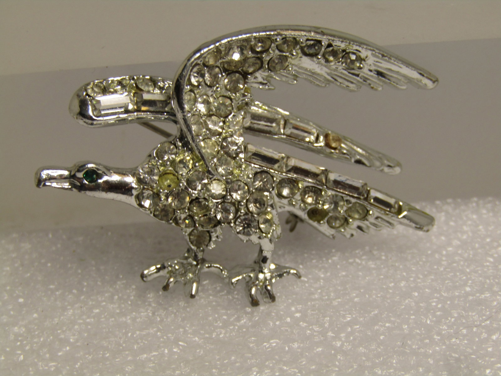 Vintage Clear Rhinestone Eagle Brooch, Baguettes/Round, 1960's: Title: Vintage Clear Rhinestone Eagle Brooch, Baguettes/Round, 1960's Description: Vintage Clear Rhinestone Eagle Brooch, Baguettes/Round, 1960's. Silver tone 2" wide and 1.25" tall eagle that has pav