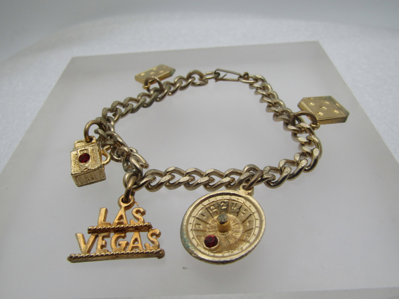Vintage Las Vegas Charm Bracelet, 1960's-1970's, 7": Title: Vintage Las Vegas Charm Bracelet, 1960's-1970's, 7" Description: Vintage Las Vegas Charm Bracelet, 1960's-1970's, 7" - God tone with a 5.5mm wide curb link chain and flip clasp and five