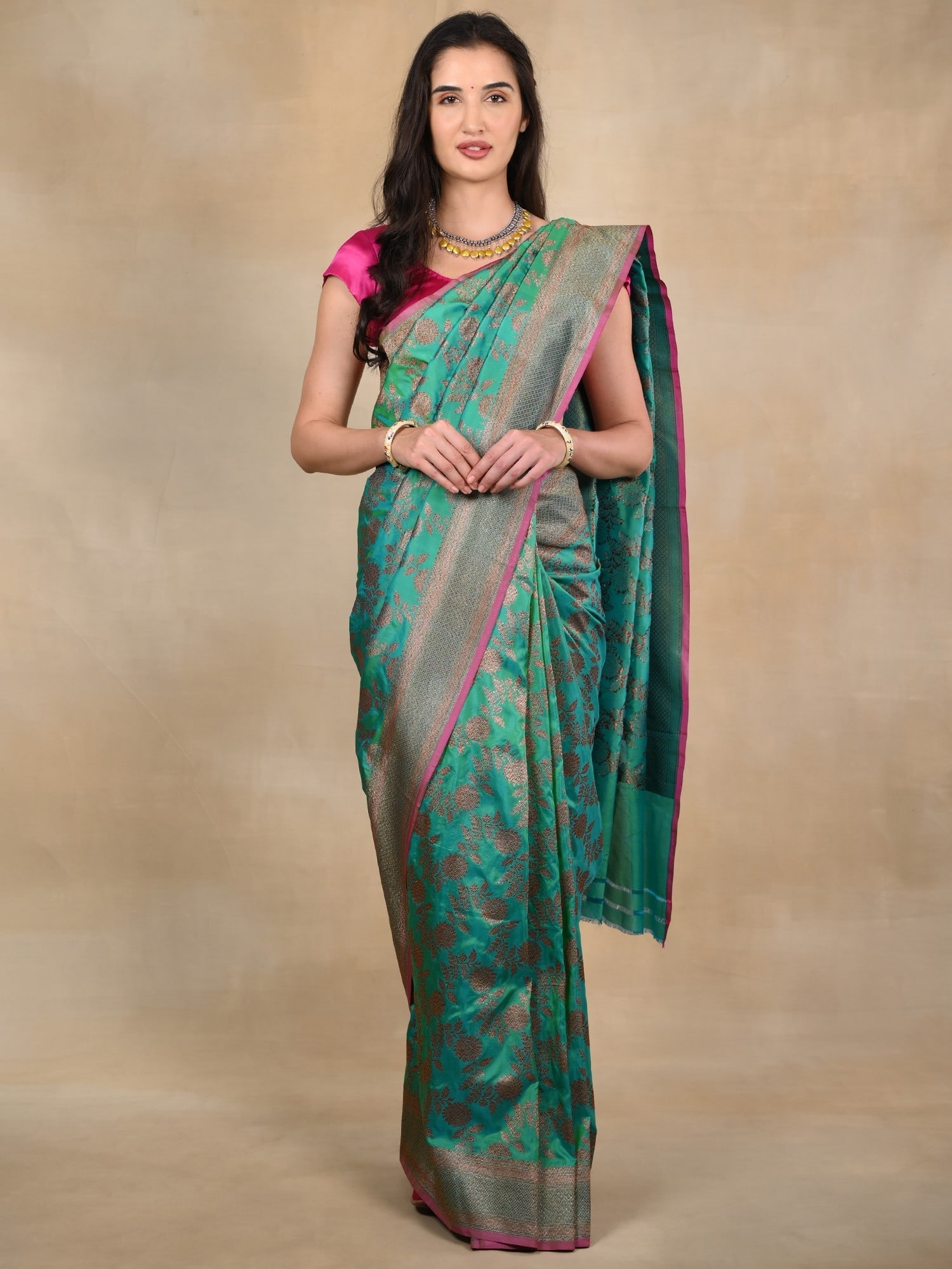 Sea Green Banarasi Saree with Magenta Pink Border and Golden Zari Motifs: Title:Sea Green Banarasi Saree with Magenta Pink Border and Golden Zari Motifs Description:The depths of the sea and the opulence of golden tones are brought together on the silken canvas of this