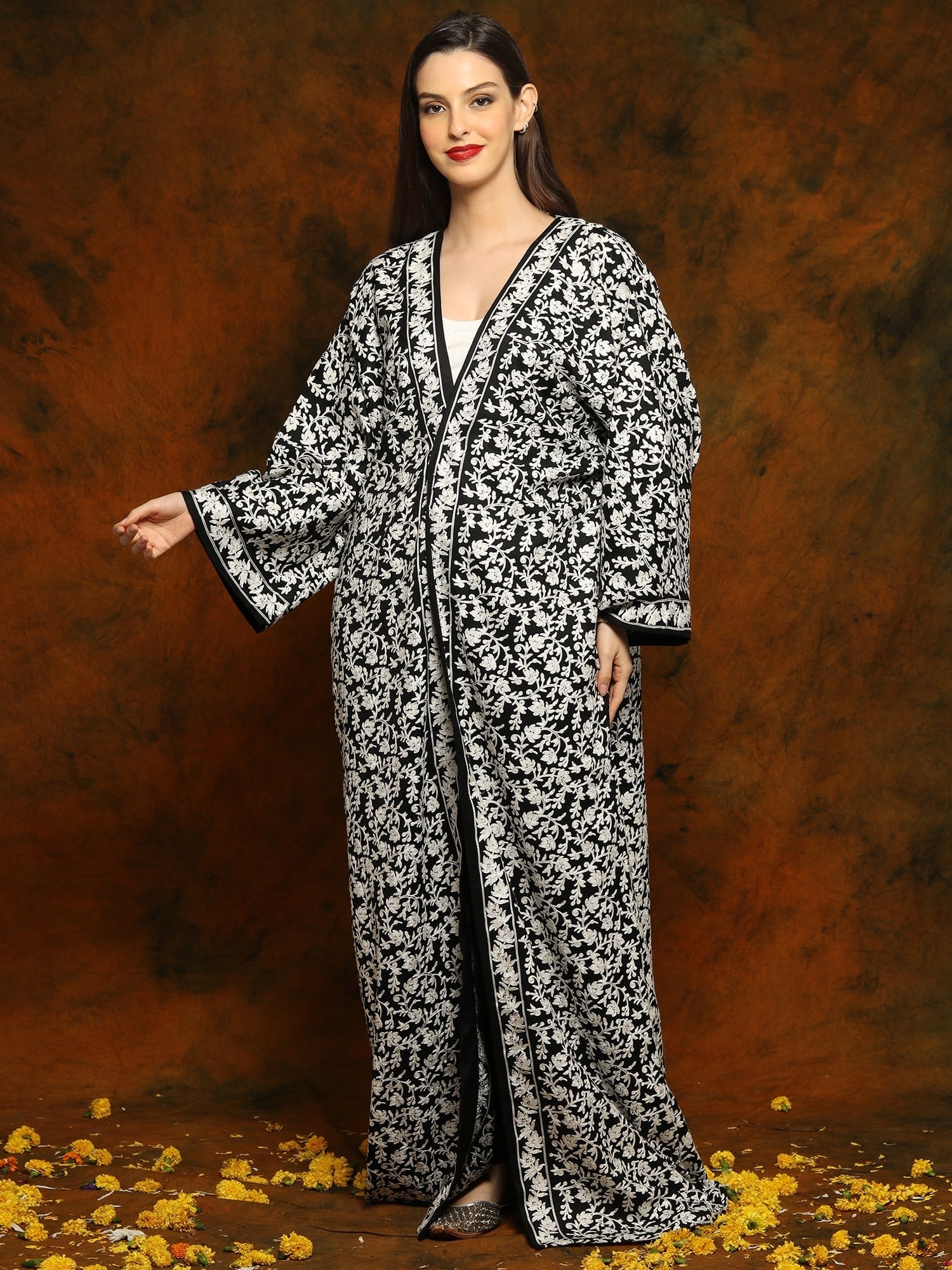 Black Fine Woolen Long Cloak with Arabian Sleeves and Detailed Floral and Paisley White Aari: Title:Black Fine Woolen Long Cloak with Arabian Sleeves and Detailed Floral and Paisley White Aari Embroidery Reference:itemcode : GAF458 Reserve: $98.00 Shipping: Domestic: Shipping rates are determi