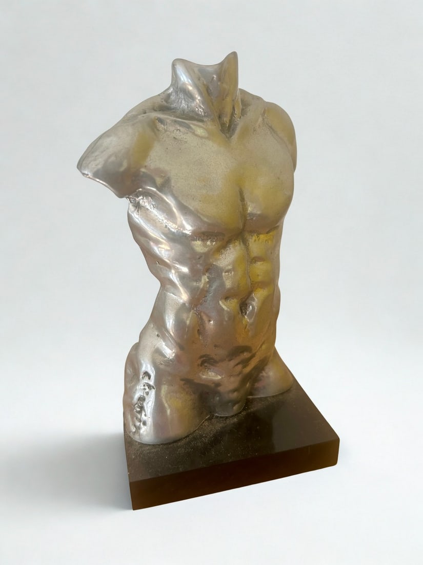 Brutalist Style Silvered Torso Sculpture on Black Plinth (Signed): This captivating Brutalist-style sculpture features a male torso, rendered in a striking silvered finish. The textured, highly sculptural surface emphasizes the muscularity and form, typical of the Br