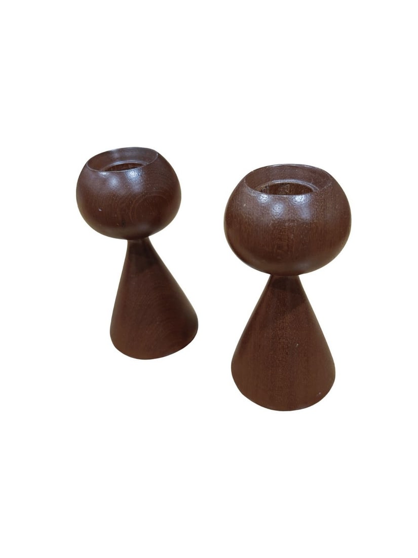Pair of Mid-Century Modern Teak Candle Holders: A simple yet elegant pair of Mid-Century Modern candle holders crafted from turned teak wood. Each holder features a spherical top with a conical base, showcasing the natural beauty and grain of the