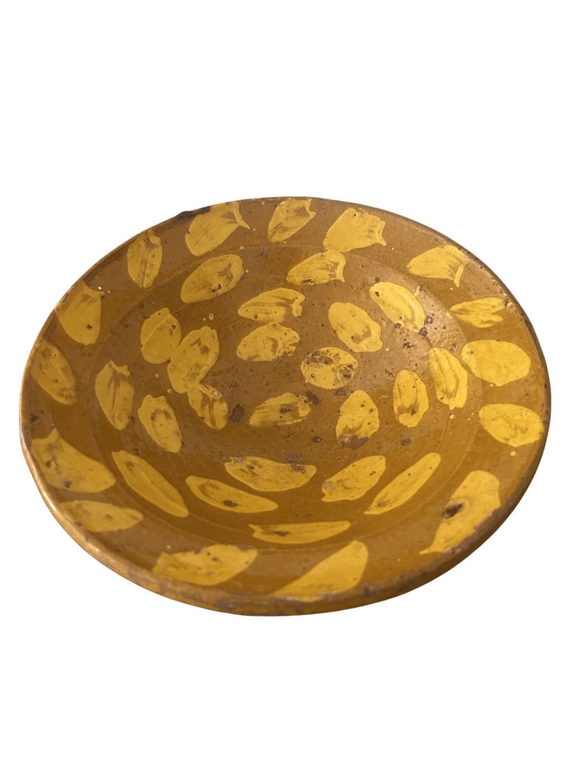 Hand-Painted Earthenware Bowl, possibly Spanish Colonial: A charming hand-painted earthenware bowl, likely of Spanish Colonial origin, featuring a warm mustard yellow glaze with irregular, abstract motifs in a brighter yellow. The bowl has a footed base and