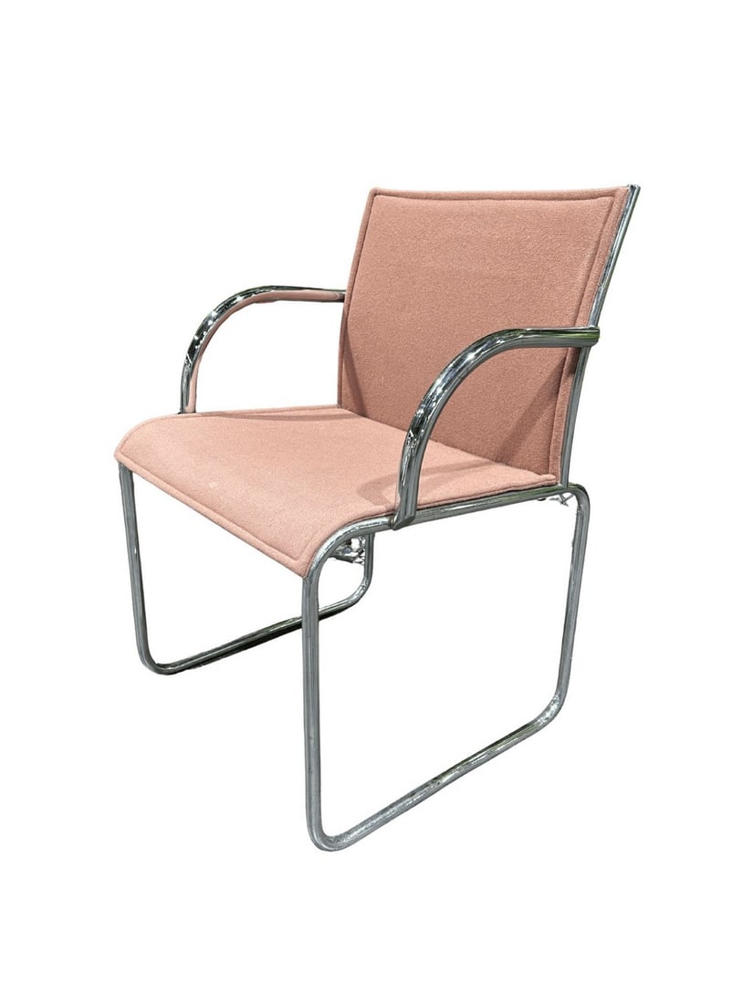Florence Knoll Mid-Century Modern Cantilever Chair, Chromed Steel and Pink Upholstery: A stylish cantilever chair from the mid-20th century, featuring a minimalist design with a continuous chromed steel tube frame. The seat and backrest are upholstered in a textured pink fabric,