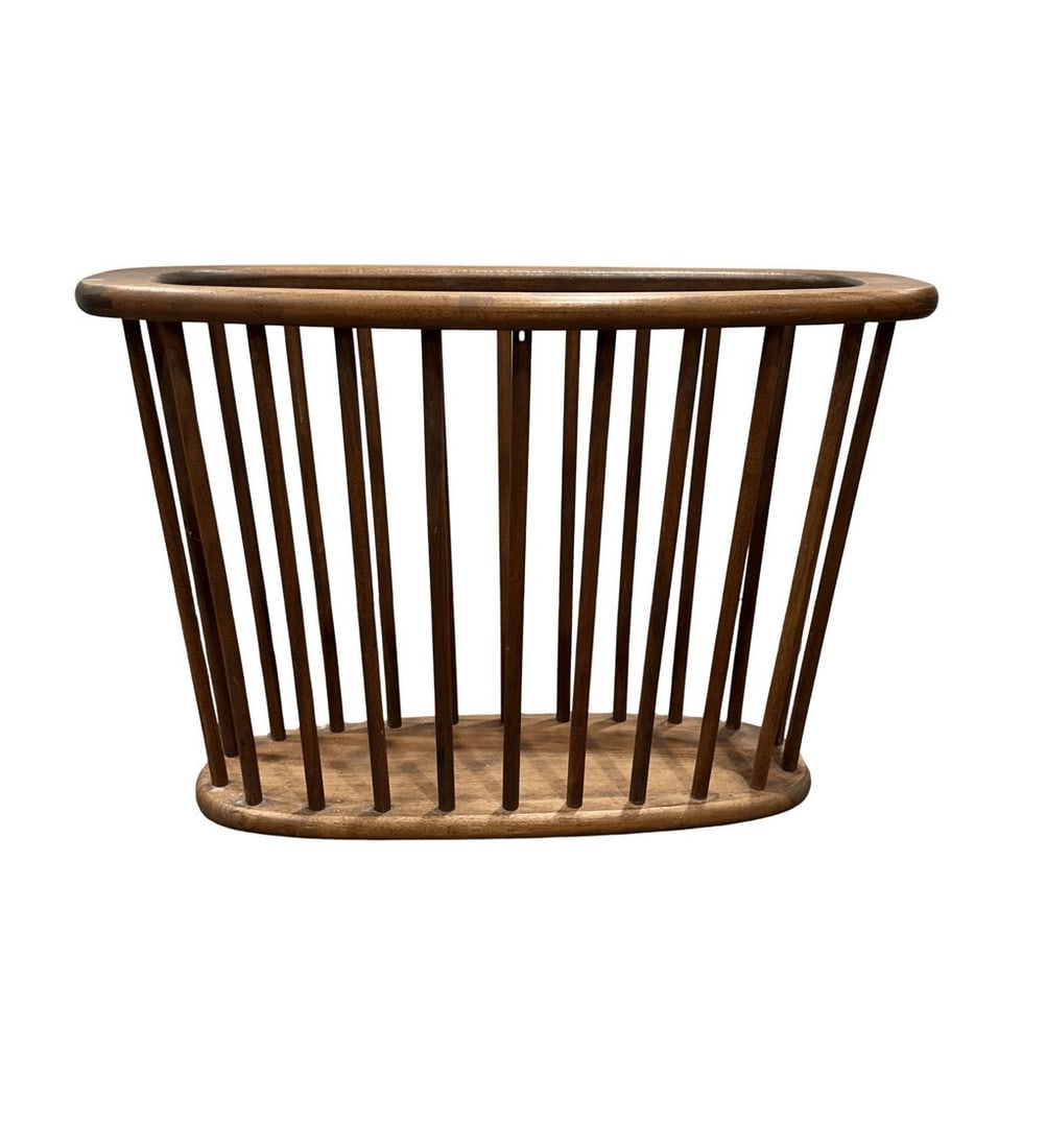 1960s Arthur Umanoff Spindled Teak Magazine Rack: A stylish Mid-Century Modern magazine rack crafted from teak wood, featuring a slatted design with an oval top and base. The minimalist aesthetic and natural wood grain are characteristic of Danish