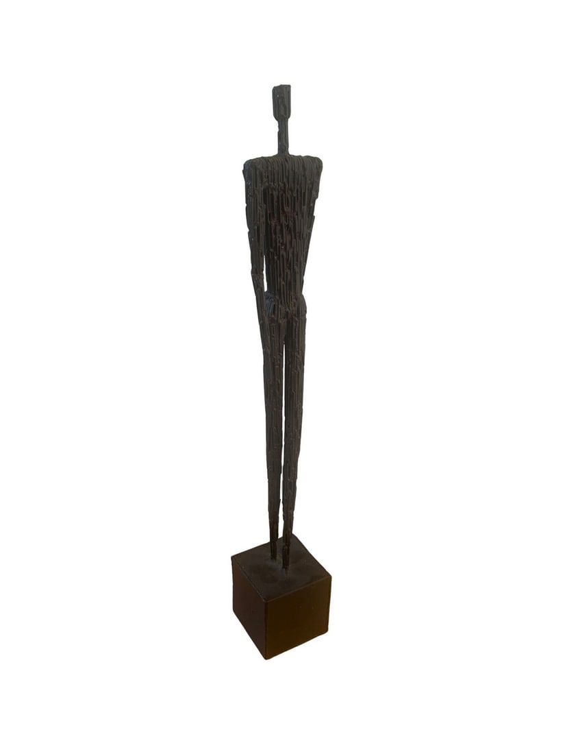 Brutalist Patinated Metal Figural Sculpture: A striking Brutalist patinated metal figural sculpture, likely dating from the mid-20th century. The piece features an elongated, abstracted human form constructed from layered and textured metal,