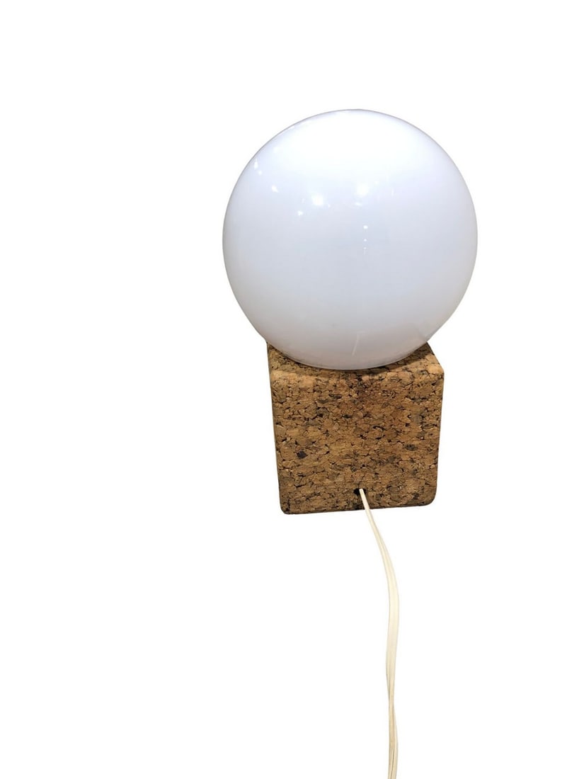 Mid-Century Modern Cork and Opal Glass Sphere Table Lamp: This unique mid-century modern table lamp features a spherical opal glass diffuser resting on a rectangular cork base. The lamp exudes a minimalist aesthetic, characteristic of the mid-20th century