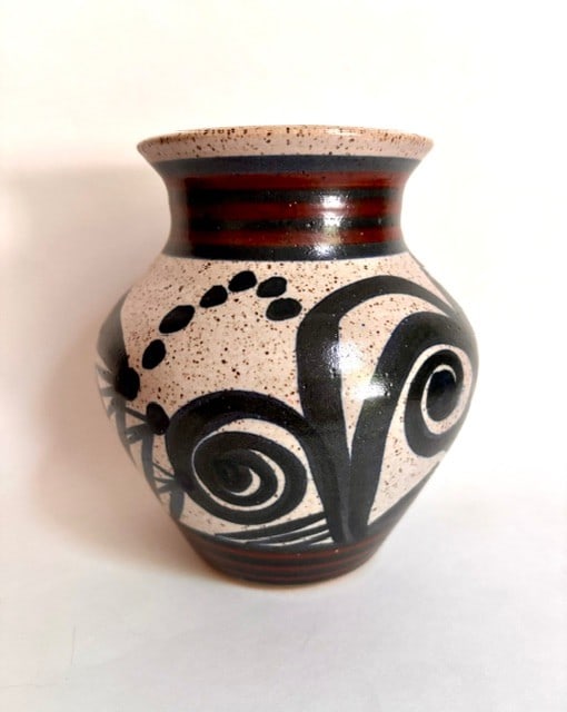 Studio Pottery Vase with Abstract Black and White Glaze: This contemporary studio pottery vase features an eye-catching abstract design. Crafted from stoneware, the vase showcases a speckled off-white glaze as its base, over which bold black brushstrokes