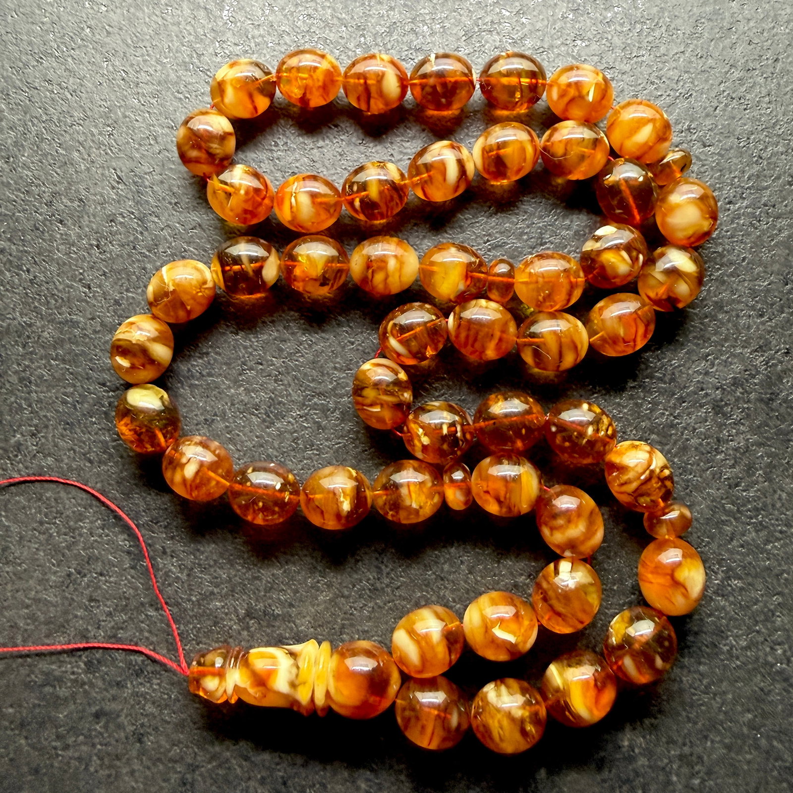 Alluring Amber Tesbih made from Round Amber beads: Title: Alluring Amber Tesbih made from Round Amber beads Metal: None Gemstone: Reconstituted Amber Weight: 72.65 g Size: 15x13 mm Made of: (Reconstituted Amber or Whole Stone): Reconstituted Amber Add