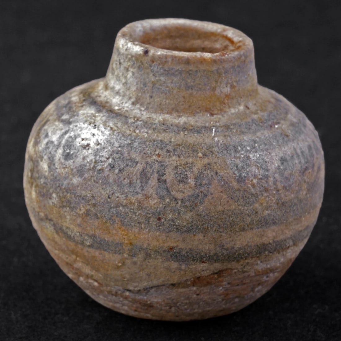 Tiny 15th/16th Thai Ceramic Pot: Title:Tiny 15th/16th Thai Ceramic Pot Size:1 3/8 in (3.5 cm) tall x 1 1/2 in (3.8 cm) diameter. Description:Tiny very old hand decorated and potted stoneware container with a fish scale decoration.