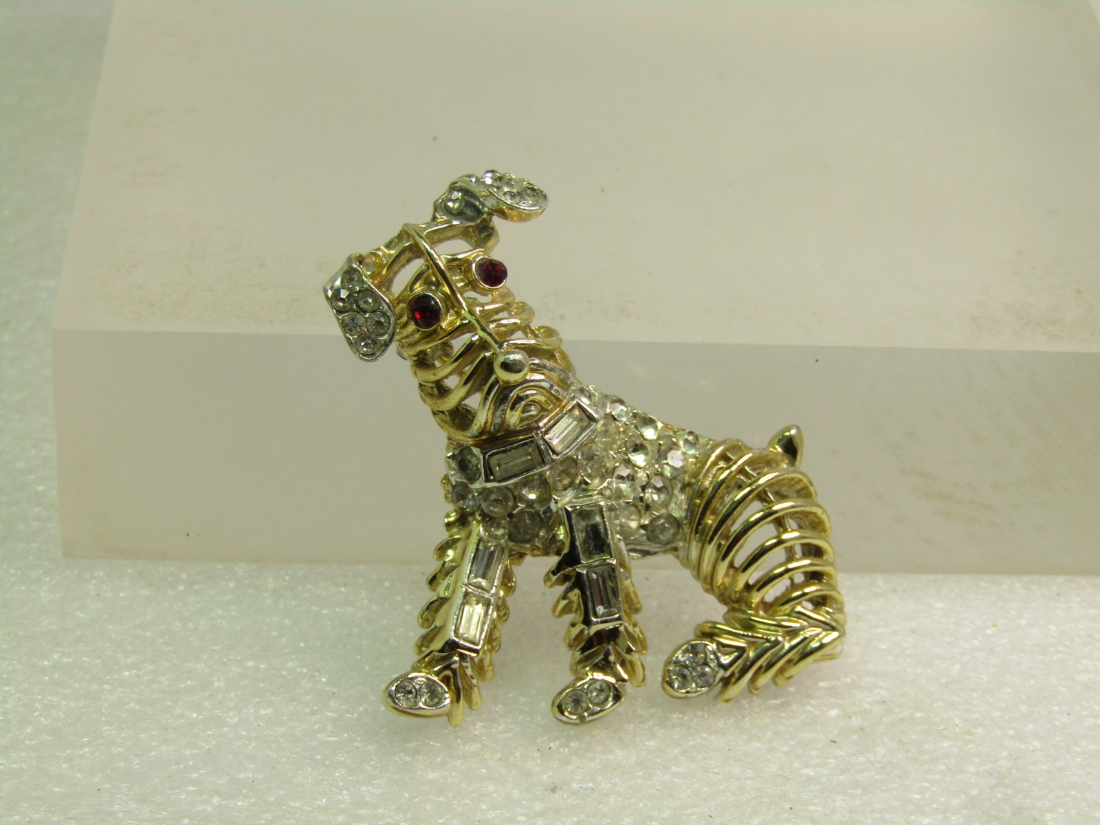 Vintage Weiss Rhinestone Dog Brooch, 1950's-1960's: Title: Vintage Weiss Rhinestone Dog Brooch, 1950's-1960's Description: Vintage Weiss Rhinestone Dog Brooch, 1950's-1960's. The dog looks like a terrier or schnauzer. It is gold tone with open design m