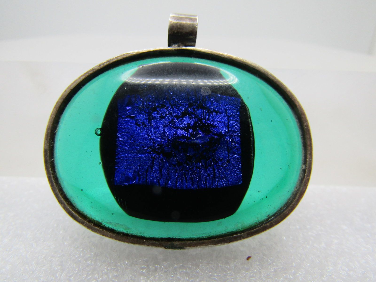 Vintage Sterling Blue and Green Glass Pendant, 1980's-1990's: Title: Vintage Sterling Blue and Green Glass Pendant, 1980's-1990's Description: Vintage Sterling Blue and Green Glass Pendant, 1980's-1990's. This is an oval bezeled glass pendant that has blue