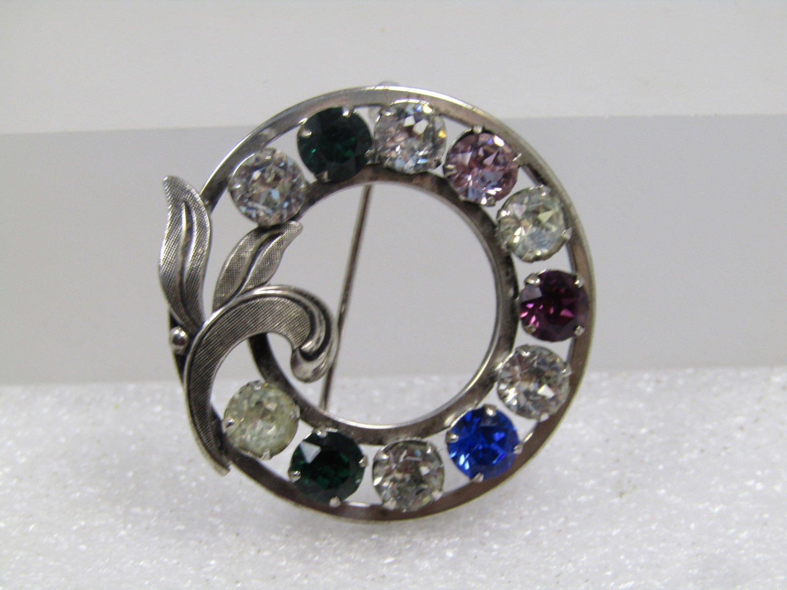 Vintage Sterling Rhinestone Circle Brooch, 1960's-1970's: Title: Vintage Sterling Rhinestone Circle Brooch, 1960's-1970's Description: Vintage Sterling Rhinestone Circle Brooch, 1960's-1970's. This has eleven round 5mm glass rhinestones in clear and alternat