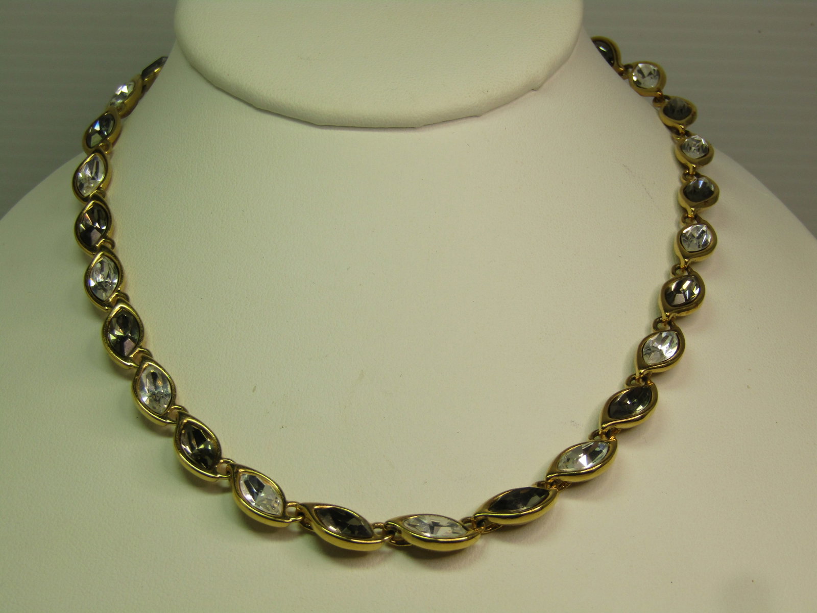 Vintage Monet Clear and Smoky Rhinestone Necklace, 17", 1970's-1980's: Title: Vintage Monet Clear and Smoky Rhinestone Necklace, 17", 1970's-1980's Description: Vintage Monet Clear and Smoky Rhinestone Necklace, 17", 1970's-1980's. This has a hook clasp where it is signe
