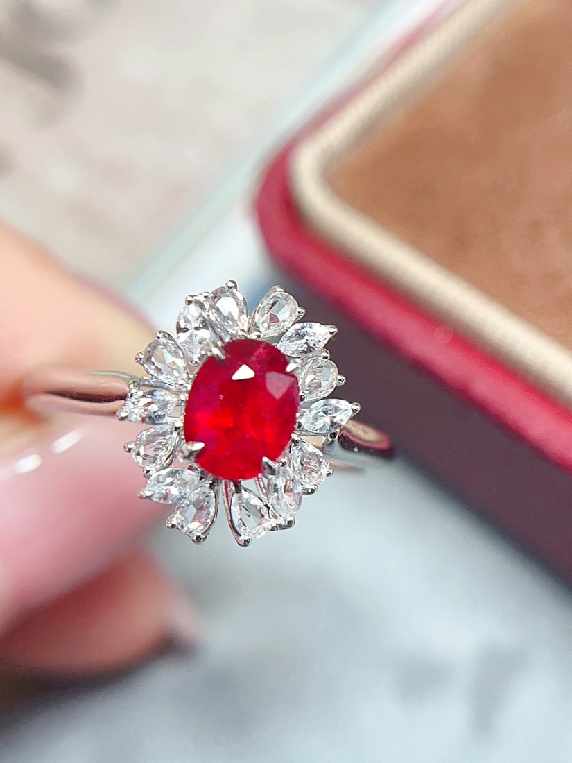 18K Gold Ruby Ring: Title: 18K Gold Ruby Ring Description: This 18K gold ruby ring showcases the classic allure of rubies. The main ruby stone has a deep hue, complemented by white sapphires, adding an elegant touch to