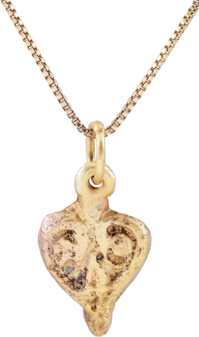 FINE ANCIENT VIKING HEART PENDANT, C.850-1050 AD: Over 1/2" (0.57") height plus the suspension loop, of iconic cusped top heart form. High rounded edge, the field as a trefoil, the top formed with the extensions of the border and the base a depressed