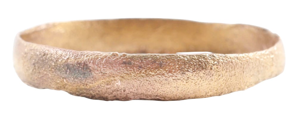 VIKING WEDDING RING, SIZE 8 1/2: 10th-11th century AD. Slightly rounded face band. 2.7mm width. Wearable size 8 1/2. Vikings exchanged rings on the pommel of the groom's sword. Surface textured from burial. Professionally refurbished
