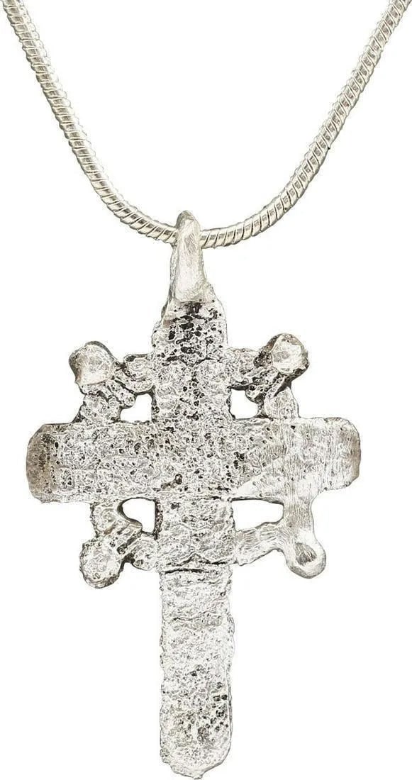 EASTERN EUROPEAN CROSS, 17th-18th CENTURY: Silvered bronze, just over 1 1/4" height including the suspension loop. The crossbeam above the center and a halo at the beam junctions with quartered radials. Age textured from burial and evidently