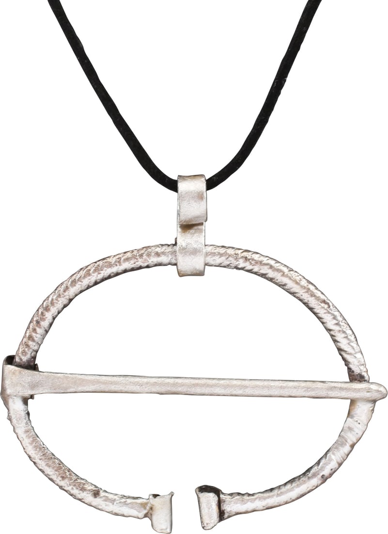 VIKING PROTECTIVE BROOCH, 850-1050 AD: Just under 2 5/8" (2.61") width, oval form, deeply reeded or roped with the ends curled. Original cross pin. Worn in numbers on the leather war jerkin, at an ounce each, a few pounds could be added