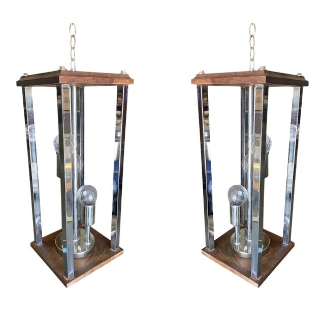 1970s Post Modern Teak and Chrome Pendant Light Fixtures - a Pair: Title: 1970s Post Modern Teak and Chrome Pendant Light Fixtures - a Pair Description: Original pair of 1970's Brutalist chandeliers with teak tops plates, chrome figures and side bars. Each comes over