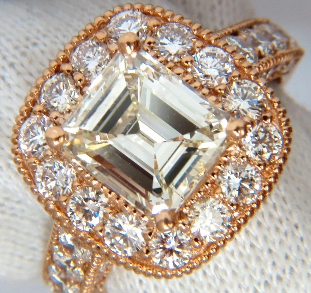 GIA CERTIFIED 5.37CT EMERALD CUT NATURAL DIAMOND RING 18KT HALO CLUSTER *v: GIA 2.97ct. Emerald cut diamond and 2.40ct. diamonds ring. Emerald cut , Excellent Clean Clarity L-color, VS-1 Clarity (GIA Report attached) 2.40cts of Side round diamonds: G-color, Vs-2 clarity. 18kt