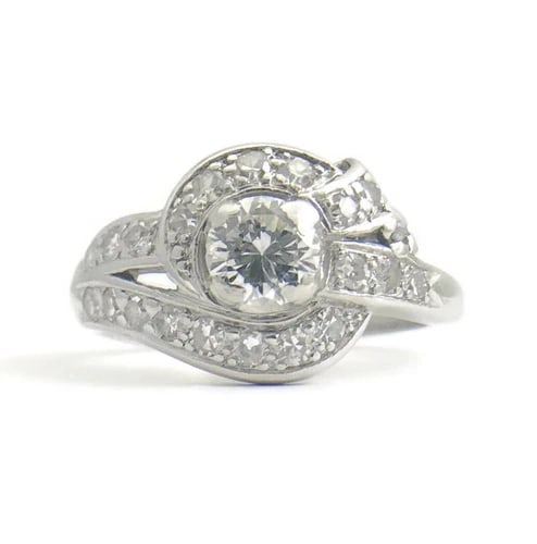 Vintage Art Deco Diamond Platinum Asymmetrical Ribbon Ring .83 ctw, 7.31 Grams: Vintage Art Deco Diamond Platinum Asymmetrical Ribbon Ring .83 ctw, 7.31 Grams This is a gorgeous, unique ring that could be worn as an engagement ring or statement ring. Please let us know if you