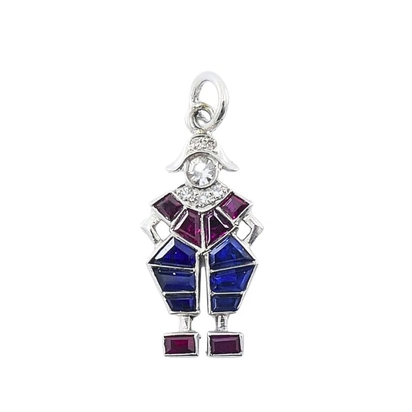 Antique Platinum Pierrot Charm Diamond & Calibre-Cut Gemstones: Title: Antique Platinum Pierrot Charm Diamond & Calibre-Cut Gemstones Description: ES ITO Product details: MATERIALS: Platinum GEMSTONE: Diamond WEIGHT: 1.3 Grams MEASUREMENTS: 1/4" x 5/8" ITEM DETAIL