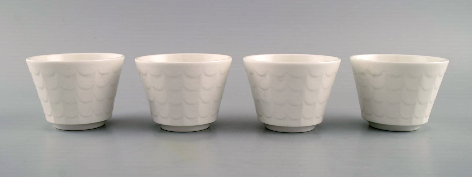Wilhelm Kage for Gustavsberg. Four flower pot covers in porcelain. Swedish design, 1960s. - 2