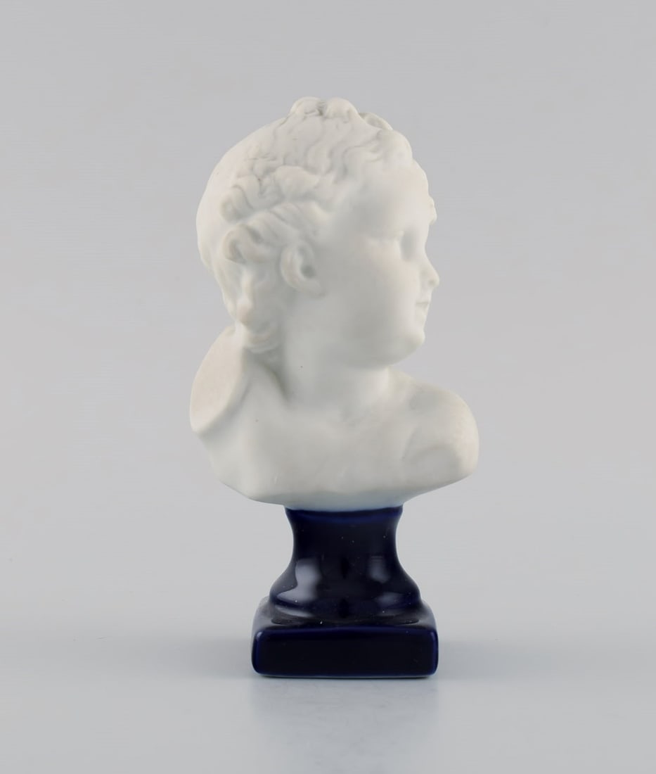 Limoges France. Biscuit child bust. Stand with dark blue glaze. Classic style. Early 20th century. - 2
