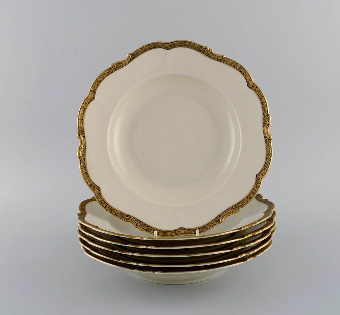KPM, Berlin. Six Royal Ivory deep plates in cream-colored porcelain with gold decoration. 1920s. - 2
