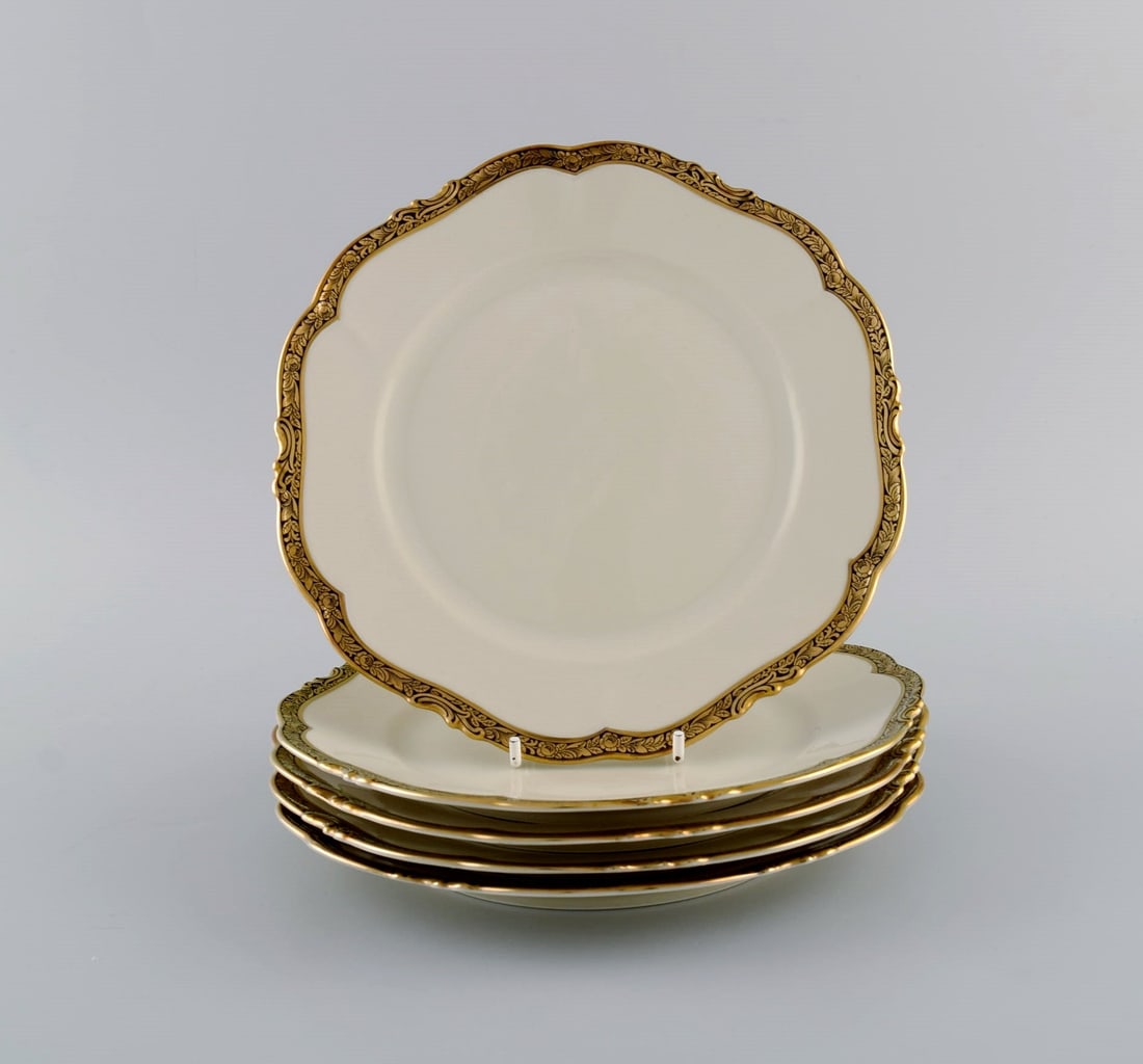 KPM, Berlin. Five Royal Ivory lunch plates in cream-colored porcelain with gold decoration. 1920s. - 2
